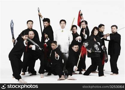 Portrait of a group of people gesturing with weapons