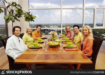Portrait of a group of people sitting at a dining table