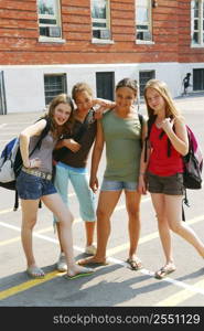 Portrait of a group of young smiling school girls in schoolyard