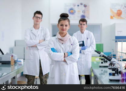 portrait of a group young medical students standing together in chemistry laboratory,teamwork by college student indoors