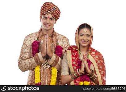 Portrait of a Gujarati bride and groom greeting