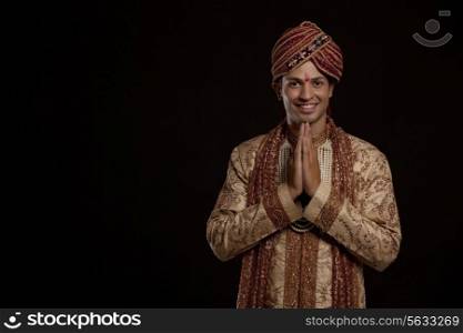 Portrait of a Gujarati groom greeting