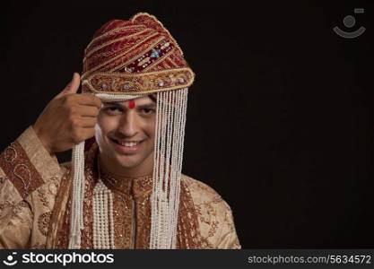 Portrait of a Gujarati groom wearing a headdress