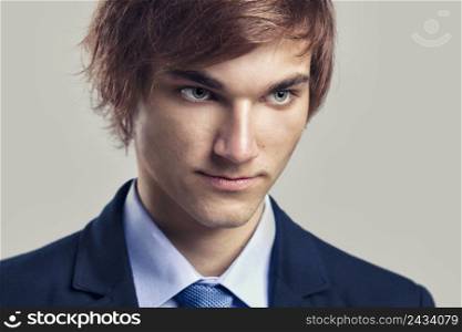 Portrait of a handsome business man, over a gray background