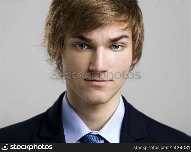 Portrait of a handsome business man, over a gray background