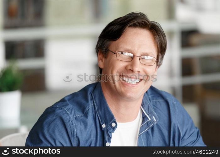 Portrait of a handsome businessman in an office smiling