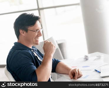 Portrait of a handsome businessman in an office smiling