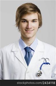Portrait of a handsome doctor, over a gray background