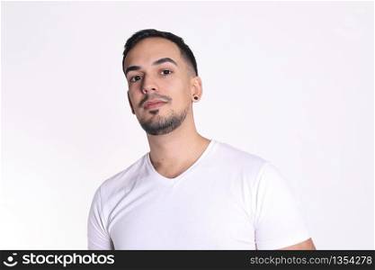 Portrait of a handsome man in white t-shirt looking at camera