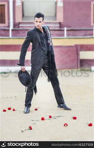 Portrait of a handsome man, model of fashion, wearing spanish clothes in a bullring