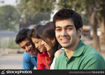 Portrait of a handsome man with friends in the background