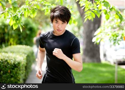 Portrait of a handsome serious man jogging in a park