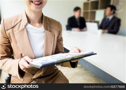 Portrait of a handsome young business women with people in background at office meeting