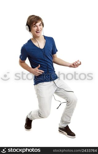 Portrait of a handsome young man dancing and listening music, isolated on white background