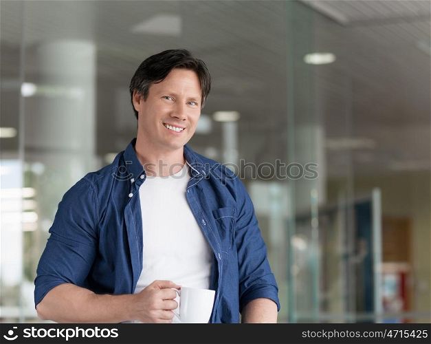 Portrait of a handsome young man in an office