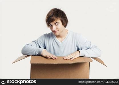 Portrait of a handsome young man inside a cardbox