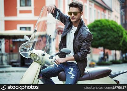 Portrait of a handsome young man on a motorbike