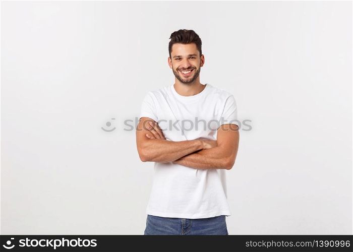Portrait of a handsome young man smiling against white background.. Portrait of a handsome young man smiling against white background