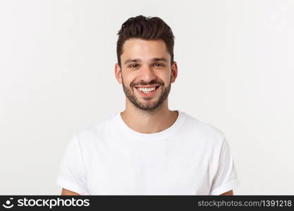 Portrait of a handsome young man smiling against yellow background.. Portrait of a handsome young man smiling against yellow background