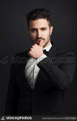 Portrait of a handsome young man wearing a tuxedo