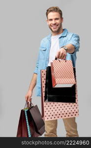 Portrait of a handsome young man with shopping bags.. Portrait of a handsome young man with shopping bags