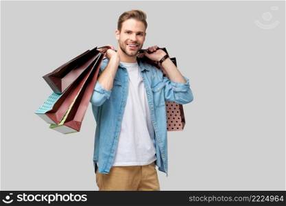 Portrait of a handsome young man with shopping bags.. Portrait of a handsome young man with shopping bags
