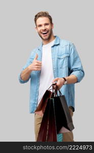 Portrait of a handsome young man with shopping bags.. Portrait of a handsome young man with shopping bags