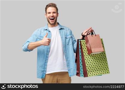 Portrait of a handsome young man with shopping bags.. Portrait of a handsome young man with shopping bags
