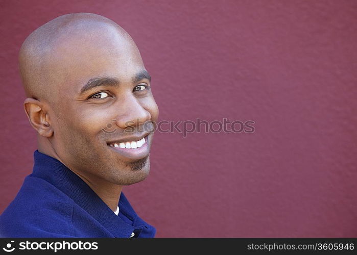 Portrait of a happy African American man over colored background