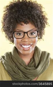Portrait of a happy African American woman wearing glasses with a stole round her neck over colored background