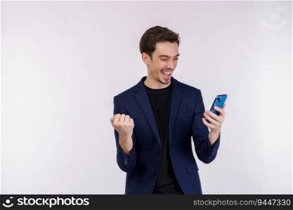 Portrait of a happy businessman using smartphone and doing winner gesture clenching fist over white background. Using mobile phone, typing sms message.
