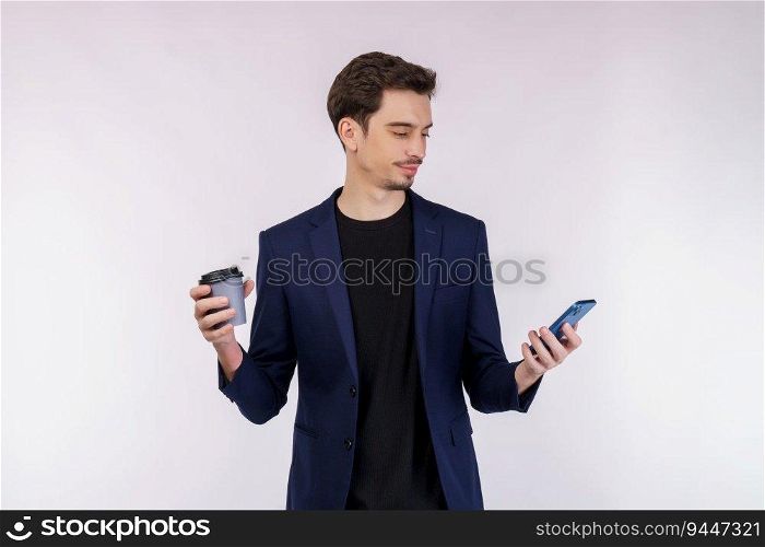Portrait of a happy businessman using smartphone and holding hot coffee over white background. Using mobile phone, typing sms message.
