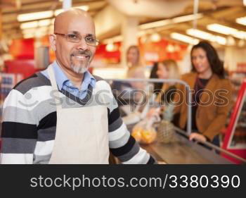 Portrait of a happy cashier with customer in the background