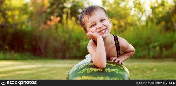 portrait of a happy child boy with a large whole watermelon in the back yard. banner. portrait of happy child boy with a large whole watermelon in the back yard. banner