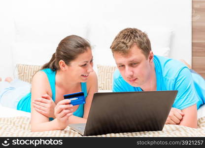 portrait of a happy couple with a credit card