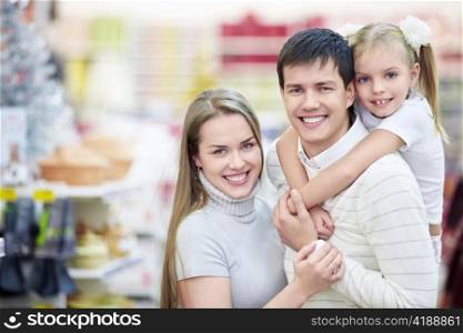 Portrait of a happy family in the store