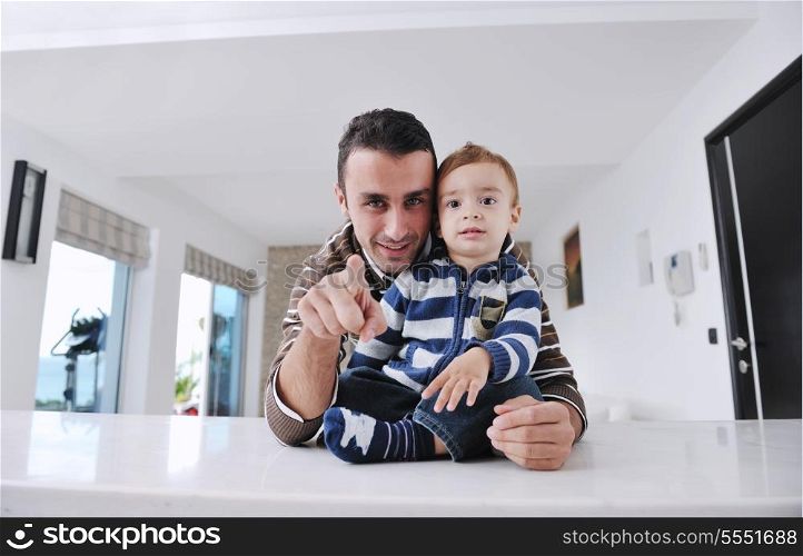 portrait of a happy father and son together in modern living room home indoor