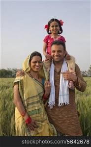 Portrait of a happy Indian family in the field
