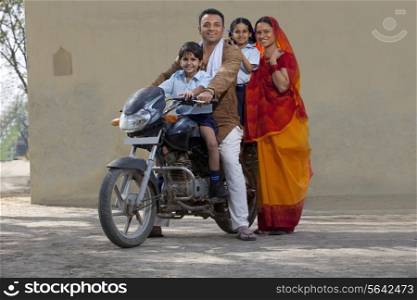 Portrait of a happy Indian family on bike