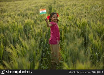 Portrait of a happy little girl holding an Indian flag