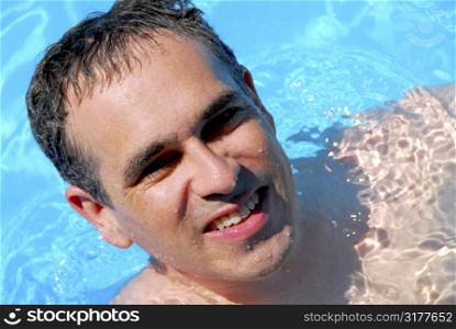 Portrait of a happy man in a swimming pool