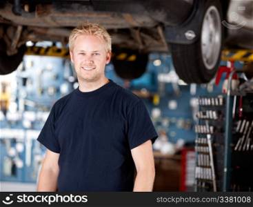 Portrait of a happy mchanic looking at the camera in garage