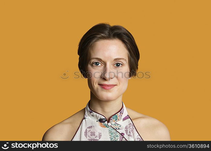 Portrait of a happy mid adult woman over colored background