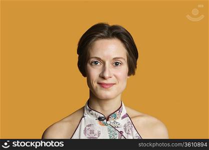 Portrait of a happy mid adult woman over colored background