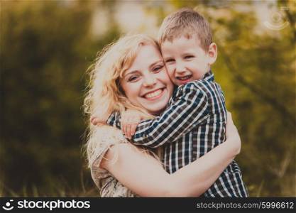 Portrait of a happy mother hugging her little son outdoor