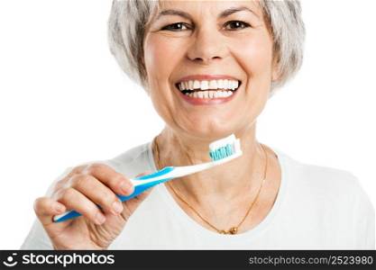 Portrait of a happy old woman brushing her teeth