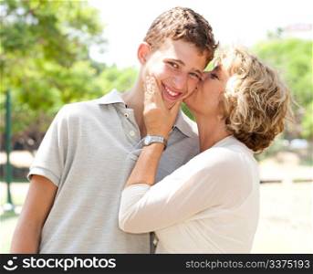Portrait of a happy old woman kissing her adorable grandson