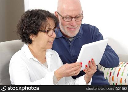 Portrait of a happy senior couple using a tablet digital