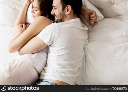 Portrait of a happy sleeping couple in their bedroom at home