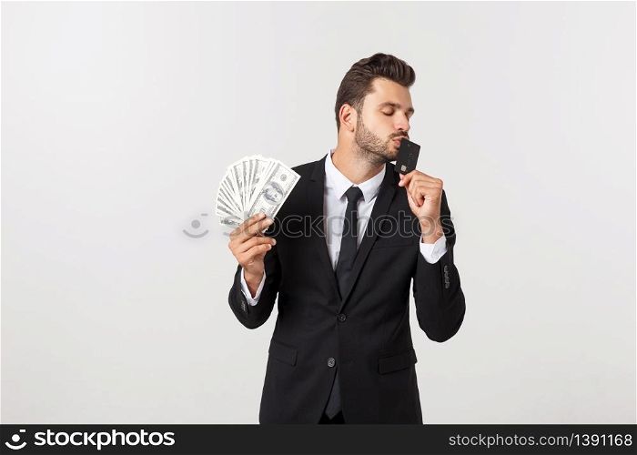 Portrait of a happy smiling man holding bunch of money banknotes and showing credit card isolated over white background. Portrait of a happy smiling man holding bunch of money banknotes and showing credit card isolated over white background.